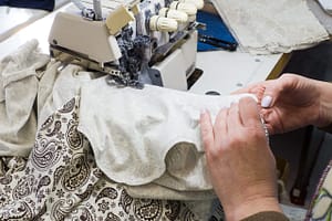 cropped-hand-woman-sewing-factory